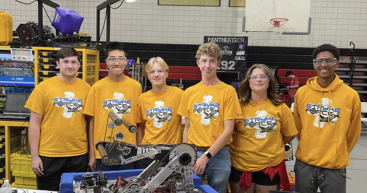 Build Team posing with robot